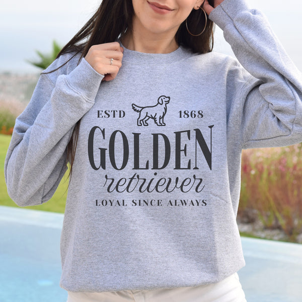 Person wearing a gray sweatshirt with 'Golden Retriever' text and design.
