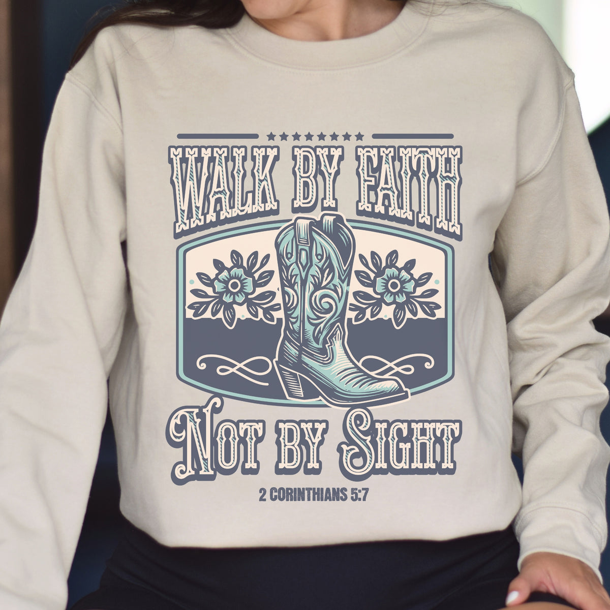 Beige sweatshirt with cowboy boots and text design on a person wearing it.