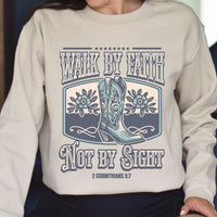 Beige sweatshirt with cowboy boots and text design on a person wearing it.