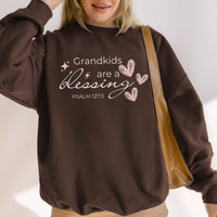 Person wearing a brown sweatshirt with 'Grandkids are a blessing' text and Psalm 127:3 quote.