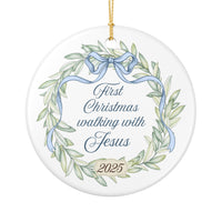 Decorative Christmas ornament with wreath design, ribbon, and text 'First Christmas walking with Jesus 2025' on a white background.