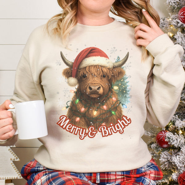 Person wearing a Christmas-themed sweater with a cow and 'Merry & Bright' text, holding a mug.