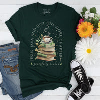 Green t-shirt with book and coffee design, surrounded by flowers and jeans on a white surface