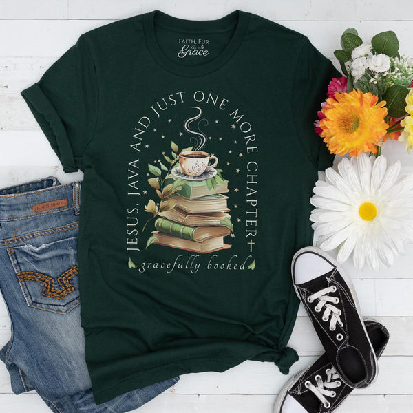 Green t-shirt with book and coffee design, surrounded by flowers and jeans on a white surface
